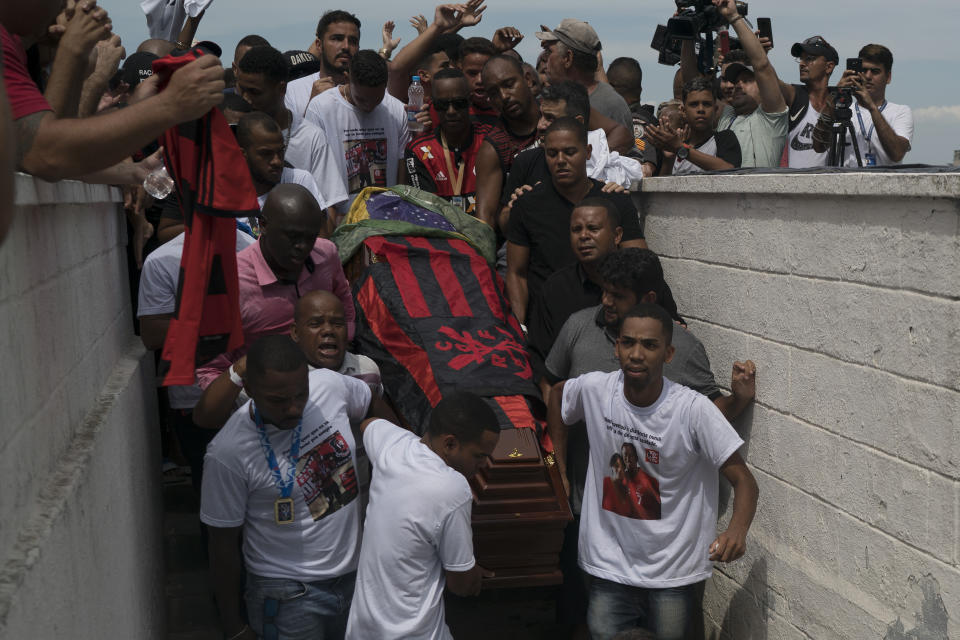 Friends and relatives carry the coffin that contain the remains of Samuel de Souza Rosa, one of the 10 young soccer players killed in a fire at the training ground of Brazilian soccer club Flamengo, during his funeral in Sao Joao de Meriti, Brazil, Monday, Feb. 11, 2019. The death of de Souza Rosa and his teammates has shed a tragic light on the state of shoddy infrastructure and lax oversight in Latin America's largest nation. (AP Photo/Leo Correa)