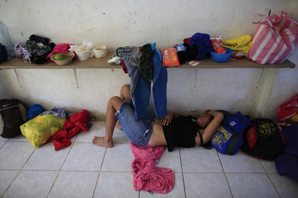 A woman naps on the tile floor of a room converted into a dormitory at the Good Shepherd migrant shelter in Tapachula, Mexico, Tuesday, June 18, 2019. Mexico's ramped-up effort to curb the flow of Central American migrants to the United States so far hasn't eased the burden on the dozens of independent humanitarian shelters like Good Shepherd that are scattered along migration routes through the country. (AP Photo/Rebecca Blackwell)