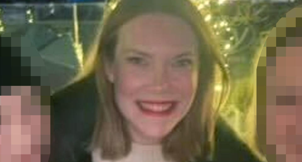 Divorcee Lauren smiling in a photo while wearing red lipstick. She has brown shoulder length hair.