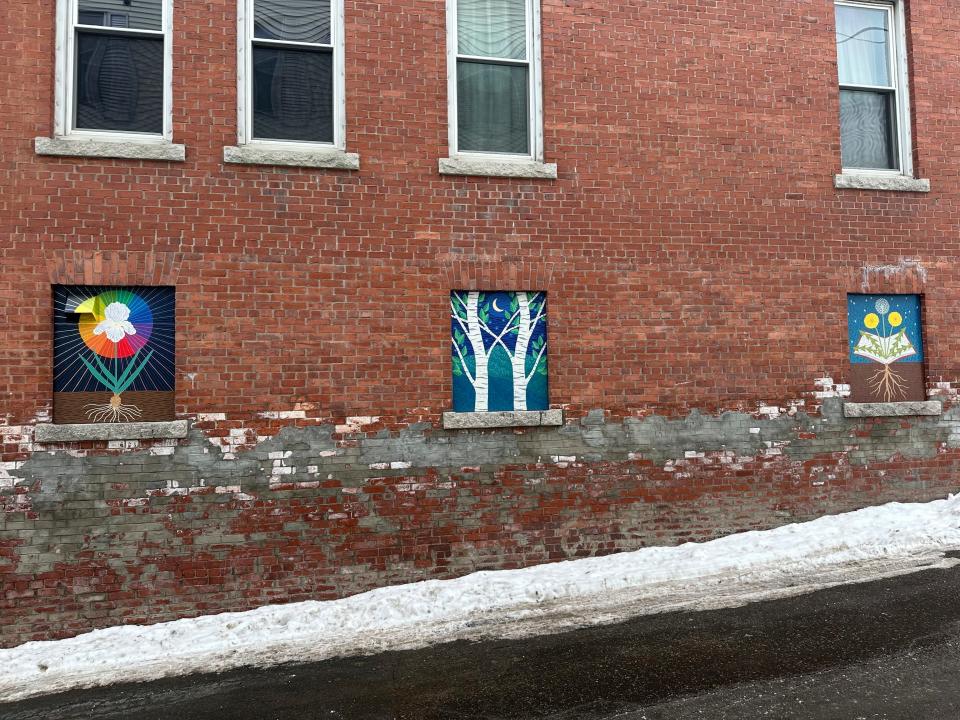 Murals deemed objectionable by some residents hang on the side of building in Littleton, N.H., on Jan 23, 2024. Littleton town manager Jim Gleason, whose late son was gay, resigned effective Friday, Feb. 2, 2024, to take a stand against the anti-LGBTQ sentiments being expressed by some people in Littleton. The quaint town of Littleton is seeing more tourists, drawn to a main street of shops and restaurants where rainbow colors and gay pride symbols can be seen alongside American flags.