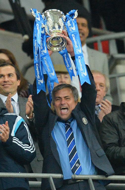 Chelsea manager Jose Mourinho lifts the trophy after winning the League Cup final against Tottenham on Sunday