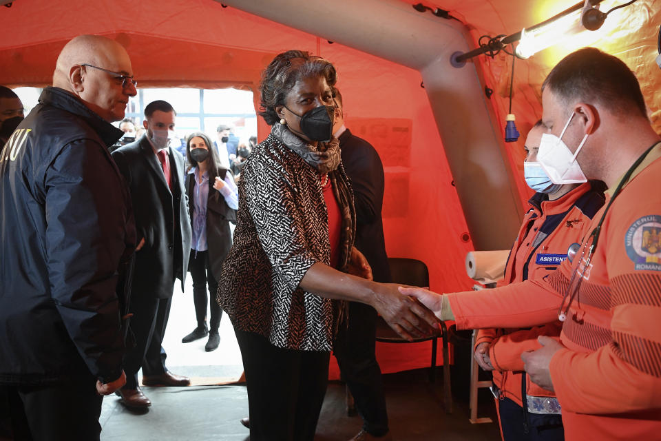 Linda Thomas-Greenfield, United States ambassador to the United Nations shakes hands with volunteers during a visit to a help center that is assisting refugees fleeing the war from neighbouring Ukraine, in Gara de Nord, the main railway station, in Bucharest, Romania, Monday, April 4, 2022. (Alex Micsik /Pool Photo via AP)