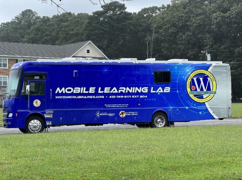 Wicomico County Library's Mobile Learning Lab sits in the parking lot behind the Wicomico Housing Authority adjacent to the Stone Grove Crossing apartments in the Westover Hills neighborhood of Salisbury on August 29, 2023. Federal Communications Commission employees boarded the bus on Tuesday to enroll eligible residents in the Affordable Connectivity Program, a benefit to provide $30 a month for low-income residents.