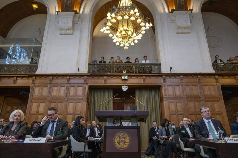 Ukraine's agent Anton Korynevych, ambassador-at-large of the Ukraine Foreign Ministry, second left, and Oksana Zolotaryova, Director General for International Law of the Ukraine Ministry of Foreign Affairs, left, wait to addresses judges at the World Court where Ukraine's legal battle against Russia over allegations of genocide used by Moscow to justify its 2022 invasion, resumed in The Hague, Netherlands, Tuesday, Sept. 19, 2023. Russia, with agent Gennady Kuzmin, ambassador-at-large of the Russian Foreign Ministry, right, seeks to have a groundbreaking case tossed out at the International Court of Justice, also known as the Word Court, in a case which will see Ukraine supported by a record 32 other nations in a major show of support for the embattled nation. (AP Photo/Peter Dejong)