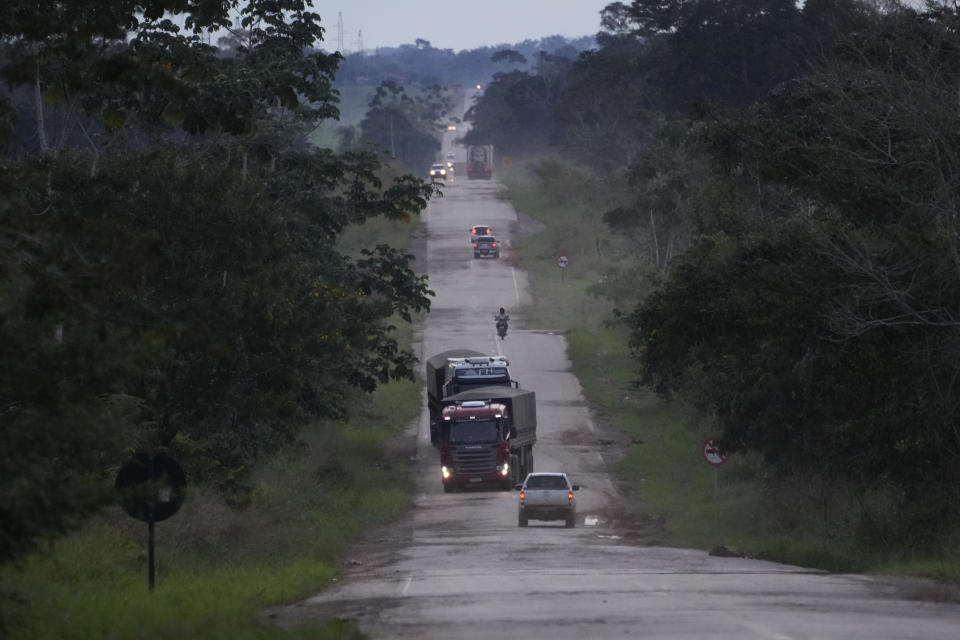 Potholes in a farm access road force trucks and vehicles to deviate from their lanes, increasing the risk of accidents, in the rural area of the Rio Branco, Acre state, Brazil, Tuesday, May 23, 2023. (AP Photo/Eraldo Peres)