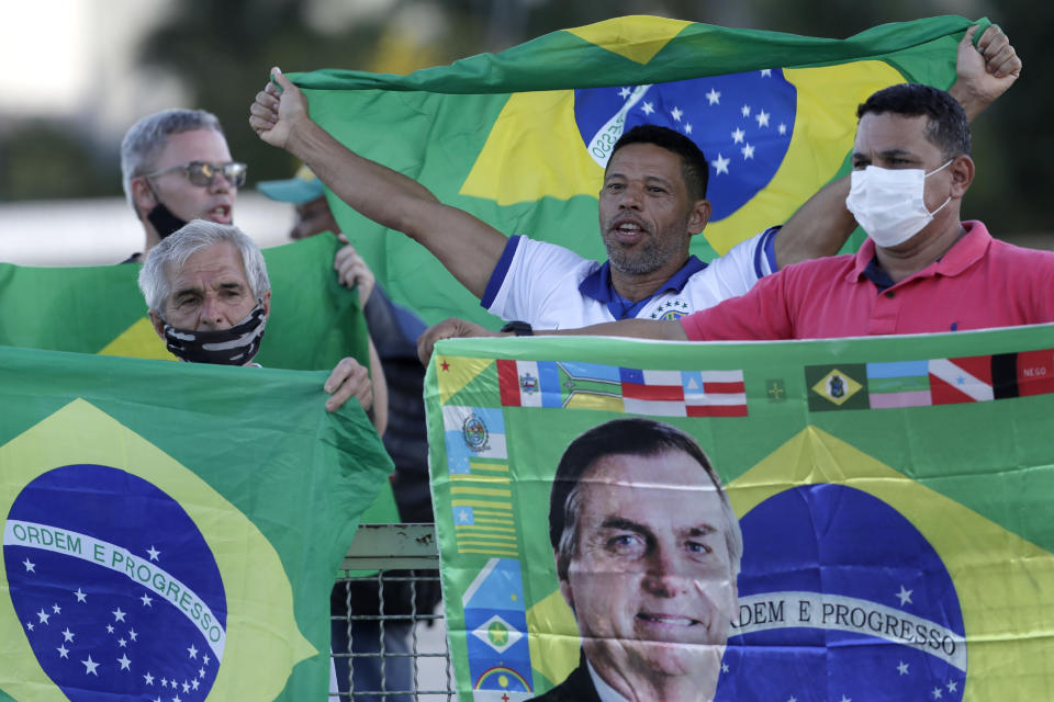Demonstrators show their support for Brazil's President Jair Bolsonaro in front of the Planalto presidential palace, in Brasilia, Brazil, Monday, March 29, 2021. President Bolsonaro has undertaken a cabinet reshuffle underscored by recent turmoil in his administration, and who has seen his approval ratings slide this year amid a raging new coronavirus pandemic that has taken the lives of more than 300,000 Brazilians. (AP Photo/Eraldo Peres)