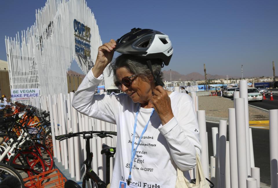 FILE - Dorothee Hildebrandt removes her bike helmet after arriving to the U.N. climate summit COP27 venue in Sharm el-Sheikh, Egypt, Nov. 12, 2022. Hildebrandt found the inspiration to focus her lifelong activism toward the climate change effort because of the younger generation. (AP Photo/Thomas Hartwell, File)