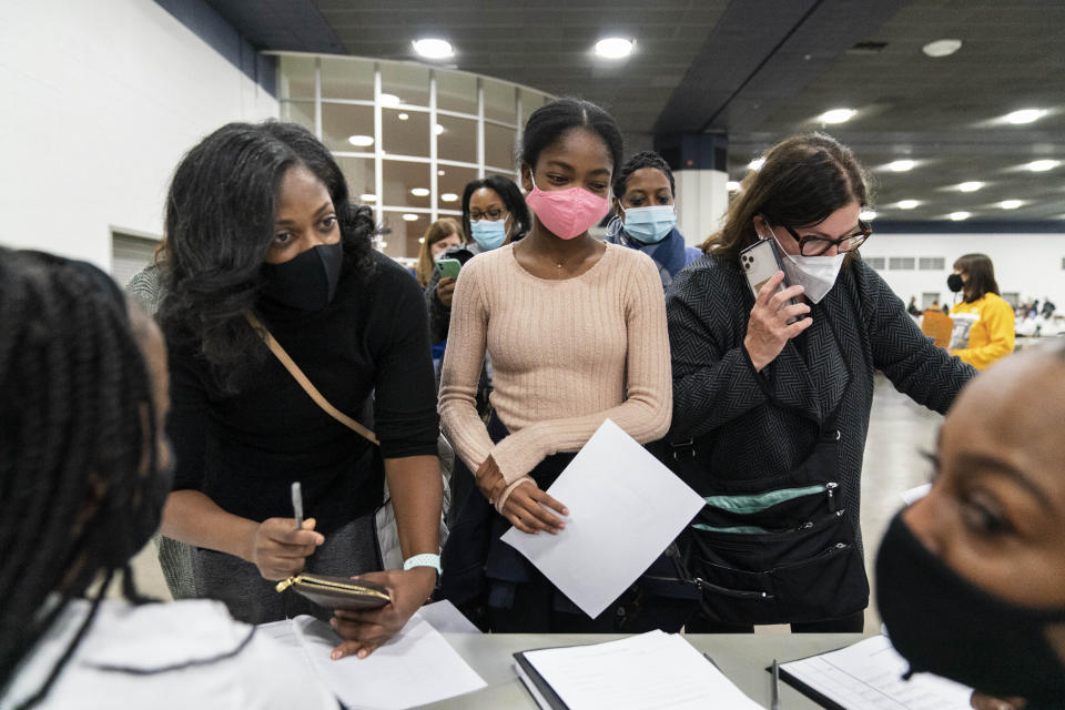 Democratic election challengers arrive at the central counting board as ballots are counted into the early morning hours Wednesday, Nov. 4, 2020 in Detroit. (AP Photo/David Goldman)