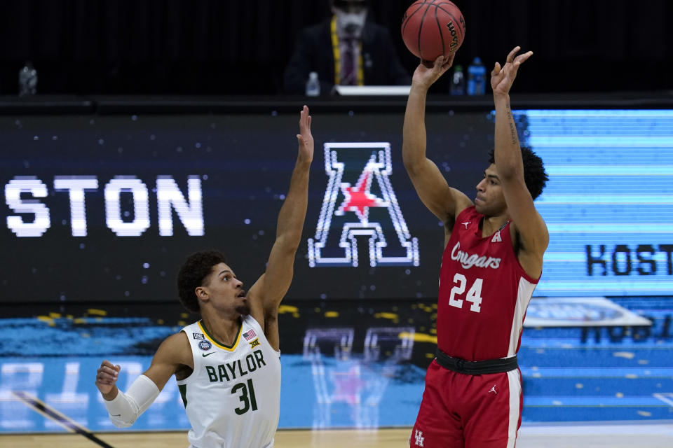 Houston guard Quentin Grimes (24) shoots over Baylor guard MaCio Teague (31) during the second half of a men's Final Four NCAA college basketball tournament semifinal game, Saturday, April 3, 2021, at Lucas Oil Stadium in Indianapolis. (AP Photo/Michael Conroy)