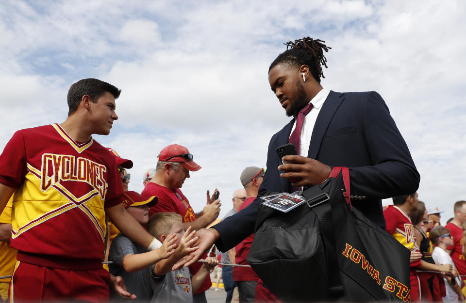 Iowa State defensive end Eyioma Uwazurike high fives fans as the team arrives to play South Dakota State in an NCAA college football game, Saturday, Sept. 1, 2018, in Ames, Iowa. (AP Photo/Matthew Putney)