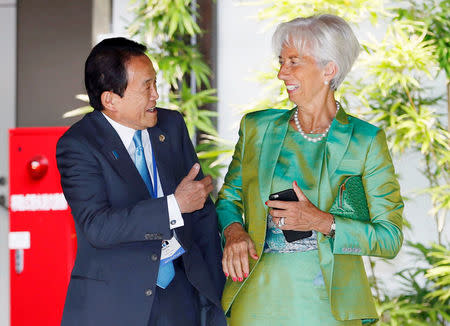 Japan's Finance Minister Taro Aso (L) talks with International Monetary Fund (IMF) Managing Director Christine Lagarde before a group photo session at the G7 finance ministers and central bankers meeting in Sendai, Miyagi prefecture, Japan, in this photo taken by Kyodo May 20, 2016. Mandatory credit Kyodo/via REUTERS