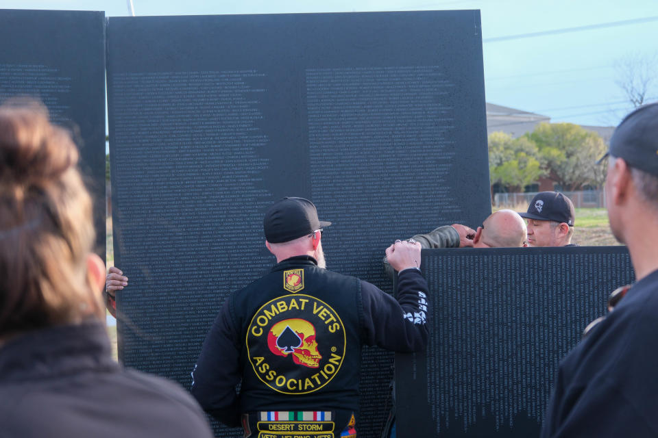 Local veteran volunteers help set up the Vietnam Traveling Memorial Wall Tuesday at the Ussery-Roan Texas State Veterans Home in Amarillo.