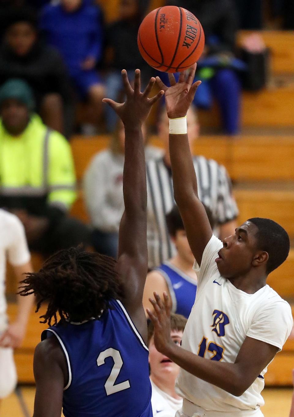 Bremerton's Dyon Sellers (12) takes a shot over North Mason's Andrew Littrean (2) during the second half of their game at Bremerton High on Tuesday, Dec. 13, 2022.