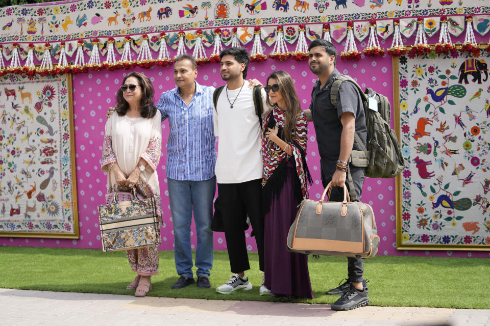 Anil Ambani, businessman and brother of Mukesh Ambani, second left, poses for a photograph with his family as he arrives to attend a pre-wedding bash of his billionaire brother's son Anant Ambani, in Jamnagar, India, Friday, March 1, 2024. (AP Photo/Ajit Solanki)