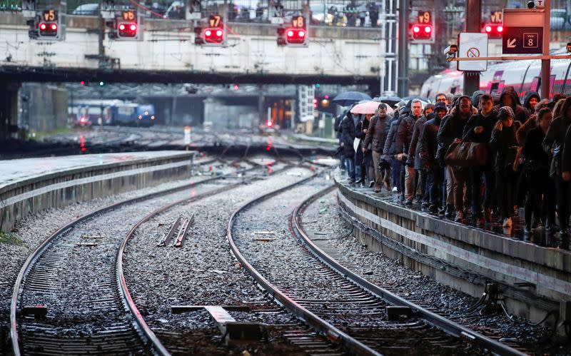 Commuters walk on a platform at Gare Saint-Lazare train station in Paris