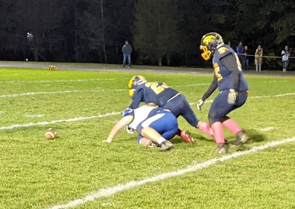 Quabbin's Luke Salvadore (23) competes with a Narragansett defender in trying to recover a Panthers fumble during a game last fall.