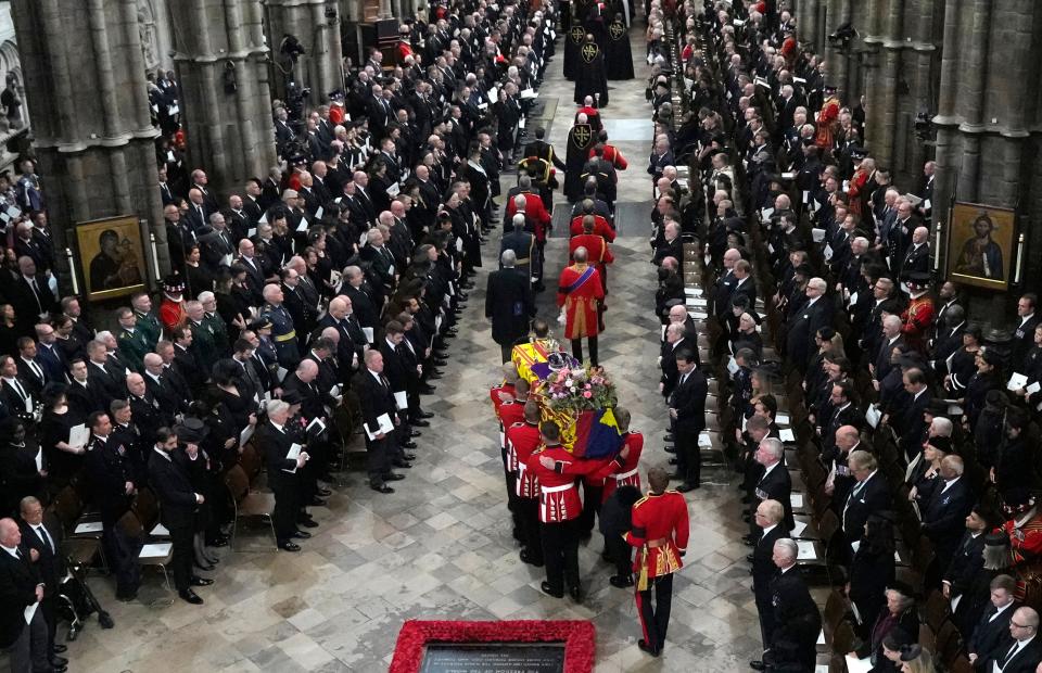 The coffin of Queen Elizabeth II is carried into Westminster Abbey for her funeral in central London, Monday, Sept. 19, 2022.