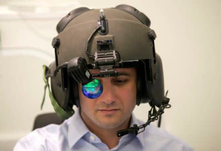 FILE PHOTO: A man demonstrates wearing Elbit System's advanced helmet mounted system, at their offices in Haifa, Israel February 26, 2017. REUTERS/Baz Ratner/File Photo