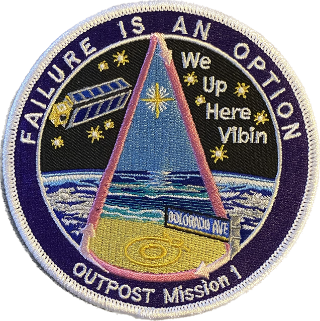 A mission patch showing a spacecraft on Earth