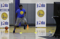 In this photo taken on Tuesday, June 9, 2020, Aalim Moor performs a drill for virtual students at Golden State Warriors basketball camp in Oakland, Calif. The State had to adapt their popular youth basketball camps and make them virtual given the COVID-19 pandemic. (AP Photo/Ben Margot)