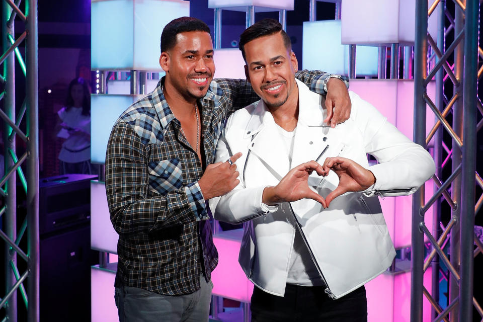 <p>Bachata crooner Romeo Santos's wax figure does his signature "heart hand" symbol at Madame Tussauds in New York City.</p>