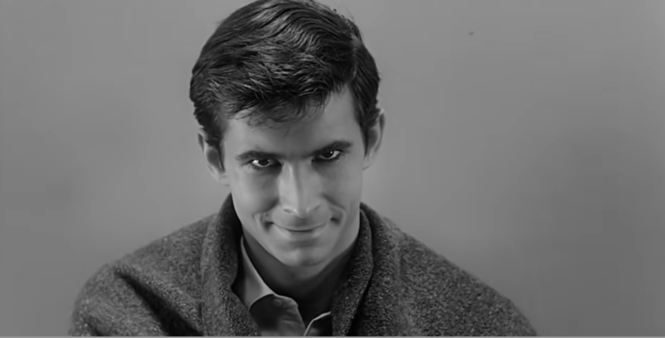 Anthony Perkins as Norman Bates smiling creepily at the camera