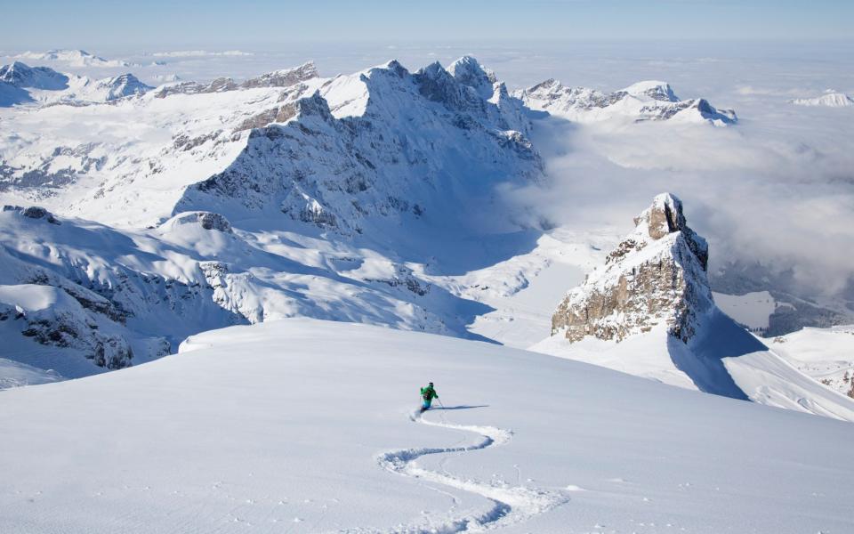 Off-piste skier in powder snow - Getty