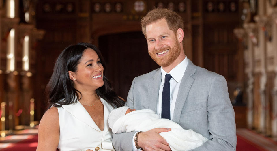Britain's Prince Harry, Duke of Sussex (R), and his wife Meghan, Duchess of Sussex, pose for a photo with their newborn baby son, Archie Harrison Mountbatten-Windsor, in St George's Hall at Windsor Castle in Windsor, west of London on May 8, 2019. (Photo by Dominic Lipinski / POOL / AFP)        (Photo credit should read DOMINIC LIPINSKI/AFP via Getty Images)