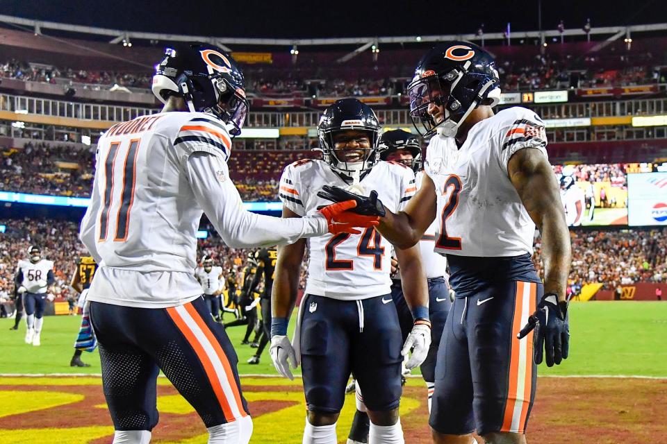 Chicago Bears wide receiver DJ Moore (2) celebrates with teammate Darnell Mooney (11) after scoring a touchdown against the Washington Commanders.