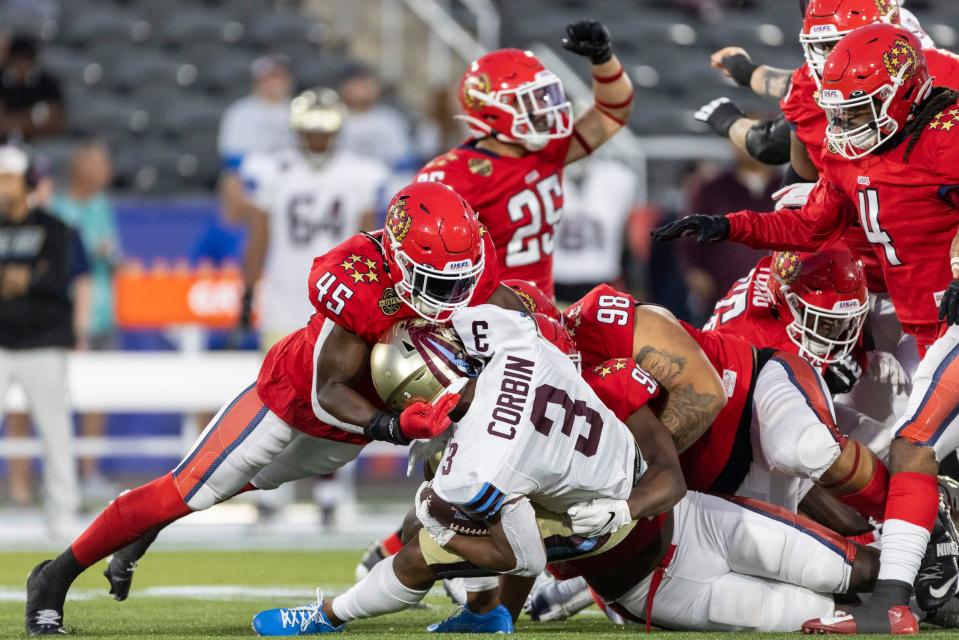 New Jersey Generals linebacker Chris Orr (45) tackles Michigan Panthers running back Reggie Corbin (3) in the first half at Protective Stadium.