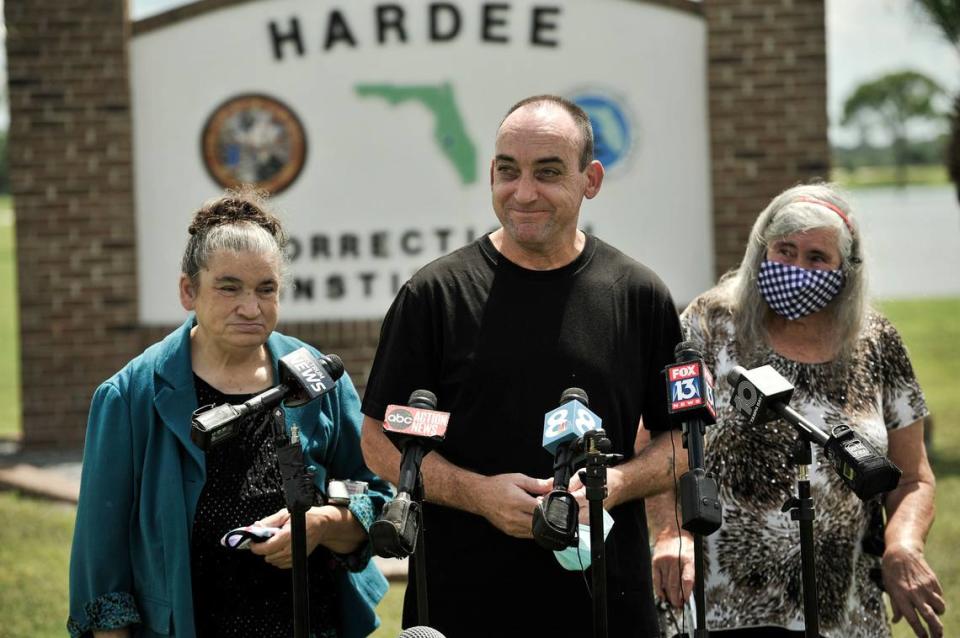 Former inmate Robert DuBoise, 56, meets reporters with his sister Harriet, left, and mother Myra, right, outside the Hardee County Correctional Institute after serving 37 years in prison, when officials discovered new evidence that proved his innocence Thursday, Aug. 27, 2020, in Hardee County, Fla. (AP Photo/Steve Nesius)
