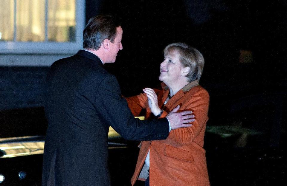 Britain's Prime Minister David Cameron, left, welcomes German Chancellor Angela Merkel, right, at 10 Downing Street, in London, Wednesday, Nov. 7, 2012. The Prime Minister said at a recent EU summit in Brussels that he would veto any proposal for the next seven-year budget framework that went above a freeze on the current position, this, in turn, allegedly left the German Chancellor prepared to scupper a summit of European leaders due on 22-23 November on the EU budget unless David Cameron withdraws the threat of a blanket veto. (AP Photo/Bogdan Maran)