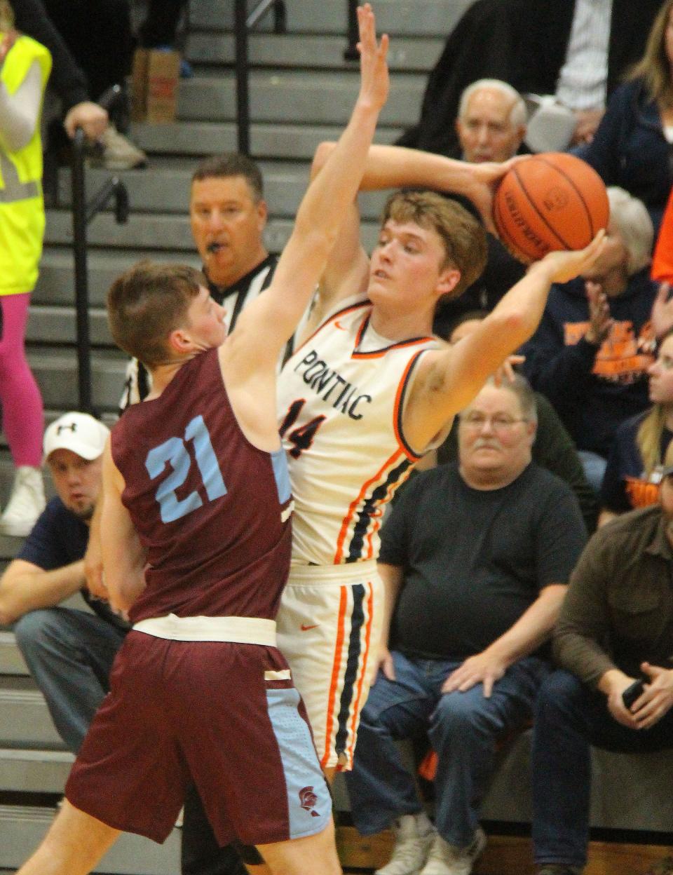 Pontiac junior Henry Brummel is pressured by McGwire Atwood of No. 6 St. Joseph-Ogden. The eighth-ranked Indians advanced to the Herscher Sectional final with a 55-40 victory.