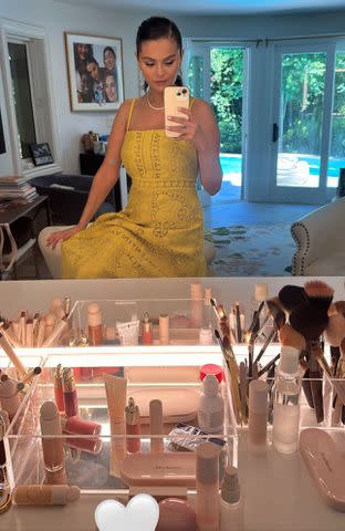 <p>Selena Gomez/Instagram</p> Selena Gomez wears a chic yellow dress next to her makeup table