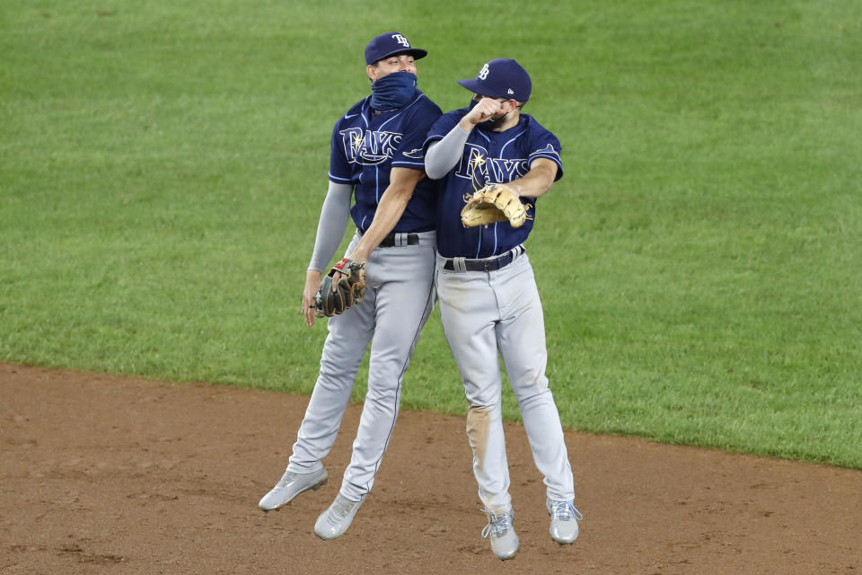 Tampa Bay Rays shortstop Willy Adames (1) celebrates with second baseman Brandon Lowe (8) after the Rays 4-2 victory over the New York Yankees in a baseball game, Wednesday, Aug. 19, 2020, in New York. (AP Photo/Kathy Willens)