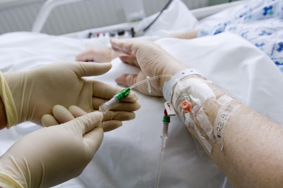 a doctor administering an IV medicine