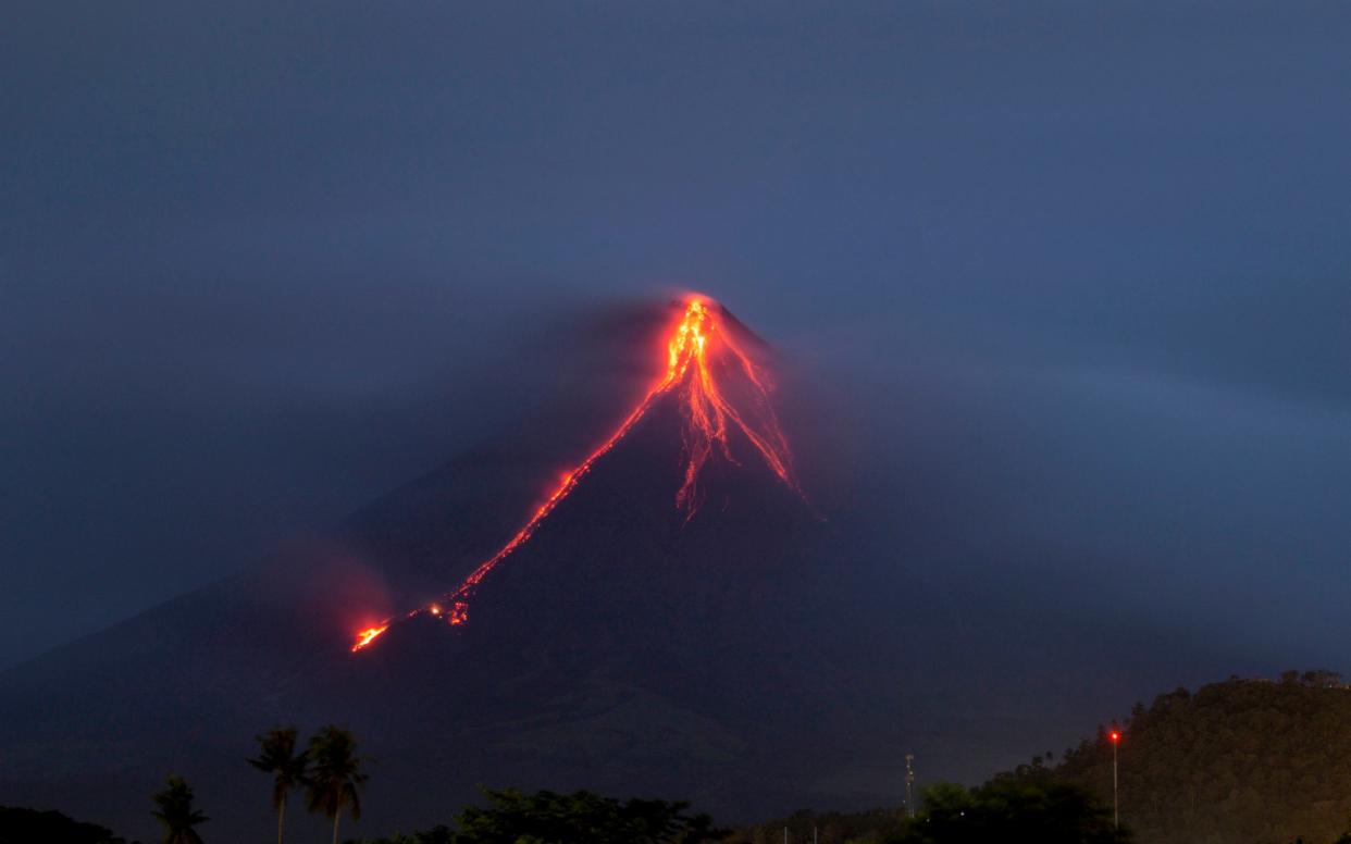 Lava cascades down the slopes of Mayon volcano, about 210 miles south-east of Manila, Philippines - STR