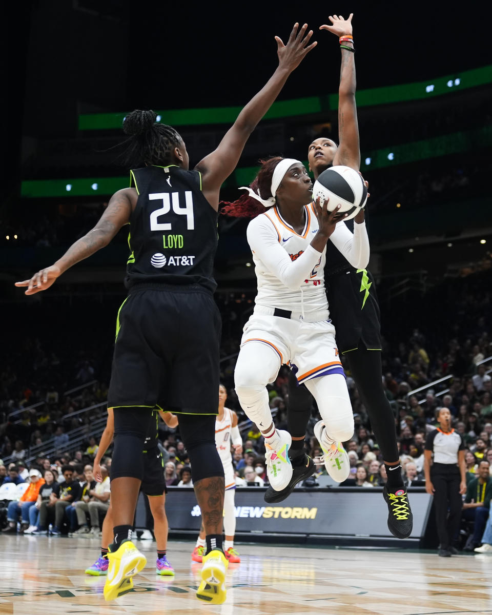 Phoenix Mercury guard Kahleah Copper, center, is fouled by Seattle Storm guard Jordan Horston, right, while guard Jewell Loyd (24) helps defend during the second half of a WNBA basketball game Tuesday, June 4, 2024, in Seattle. The Storm won 80-62. (AP Photo/Lindsey Wasson)