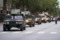 Kentucky National Guard troops arrive, Thursday, Sept. 24, 2020, in Louisville, Ky. Authorities pleaded for calm while activists vowed to fight on Thursday in Kentucky's largest city, where a gunman wounded two police officers during anguished protests following the decision not to charge officers for killing Breonna Taylor. (AP Photo/Darron Cummings)