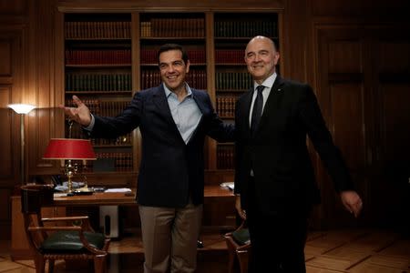 Greek Prime Minister Alexis Tsipras welcomes European Economic and Financial Affairs Commissioner Pierre Moscovici at his office in Maximos Mansion in Athens, Greece July 25, 2017. REUTERS/Alkis Konstantinidis