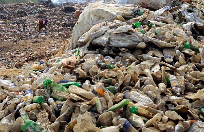 FILE PHOTO: A woman collects plastic bottles for recycling at the garbage dump on the outskirts of Agartala