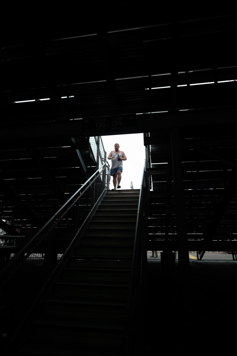 People exit the stands due to a rain delay during the Ally 400 at the Nashville Superspeedway in Lebanon, Tenn., Sunday, June 26, 2022.