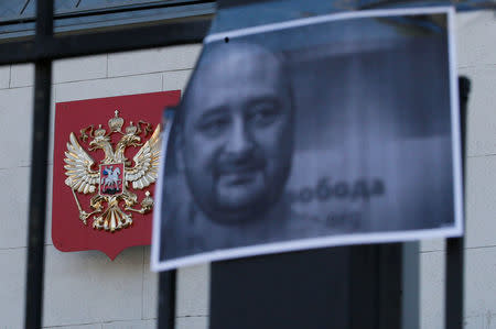 A picture of Russian dissident journalist Arkady Babchenko, who was shot dead in the Ukrainian capital on May 29, hangs from a fence of the Russian embassy in Kiev, Ukraine May 30, 2018. REUTERS/Gleb Garanich