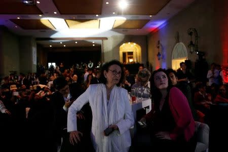 A woman watches a broadcast of the U.S. Presidential electoral race between U.S. Democratic presidential candidate Hillary Clinton and U.S. Republican presidential nominee Donald Trump, in a restaurant in Mexico City, Mexico November 9, 2016. REUTERS/Carlos Jasso