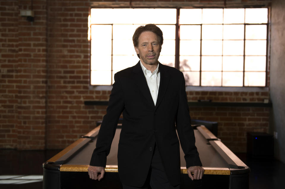 In this Monday, Jan. 13, 2014 photo, Jerry Bruckheimer poses for a portrait at his office in Santa Monica, Calif. After more than two decades with Disney, where he produced the juggernaut “Pirates of the Caribbean” and “National Treasure” film franchises among many box-office hits, Bruckheimer begins a new partnership with Paramount in March 2014. At Disney’s behest, he closes his previous chapter with a photo book as outsized as some of his productions: “Jerry Bruckheimer: When Lightning Strikes - Four Decades of Filmmaking” is a 10-pound, 300-page chronicle of his career in pictures. (Photo by Jordan Strauss/Invision/AP)