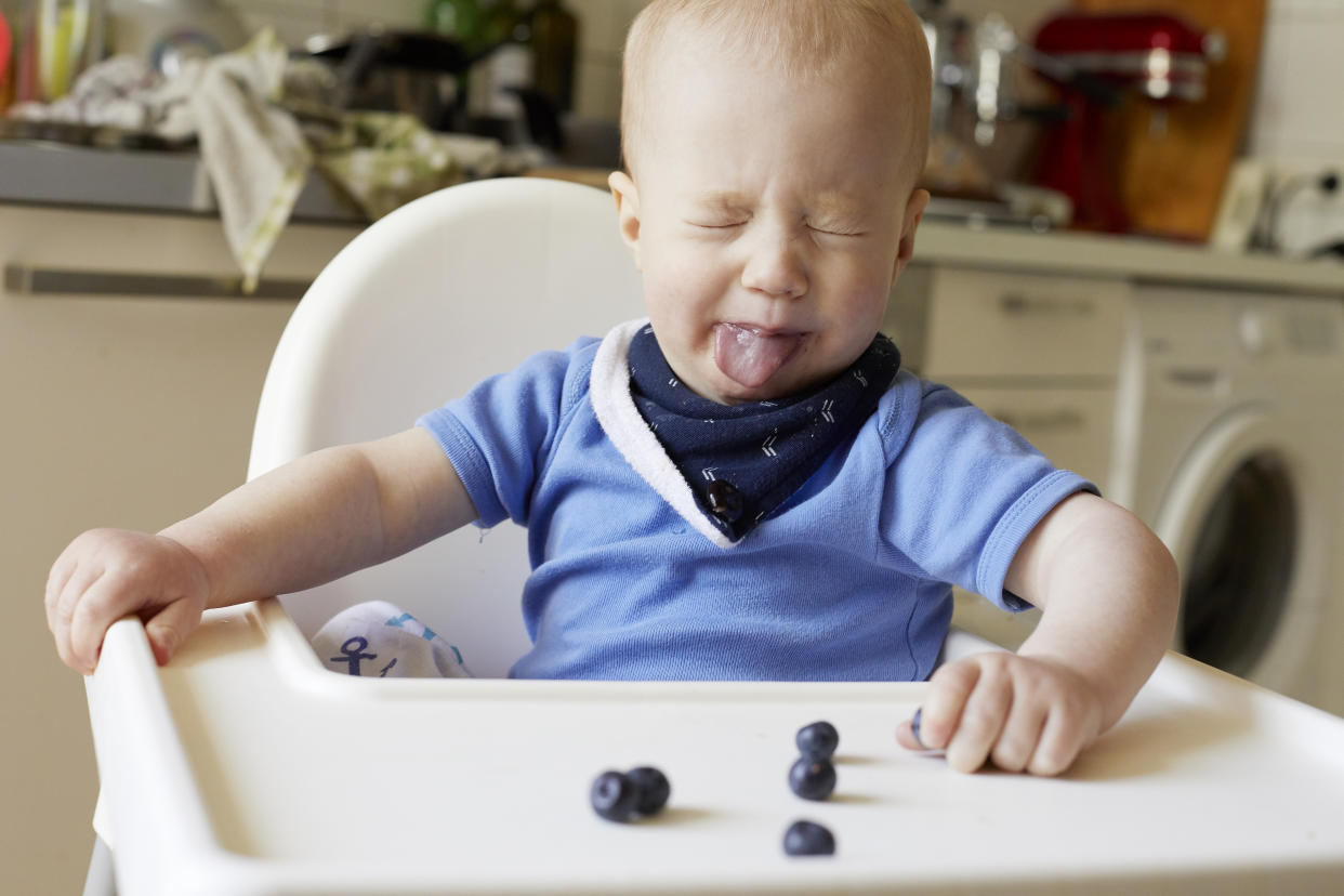 A baby making a face at his food, but introducing Introducing new foods to children at a young age could reduce their risk of developing allergies. (Getty Images)