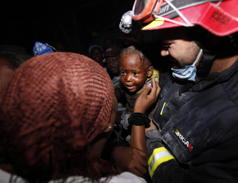 <p>Two year old Redjeson Hausteen Claude reacts to his mother Daphnee Plaisin, after he is rescued from a collapsed home by Belgian and Spanish rescuers in the aftermath of the powerful earthquake in Port-au-Prince, Thursday, Jan. 14, 2010. (Photo: Gerald Herbert/AP) </p>
