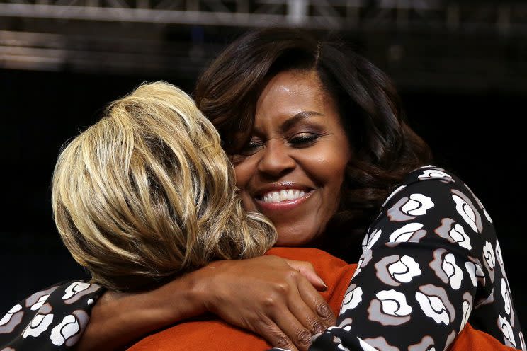 Michelle Obama embraces Hillary Clinton as they arrive at a campaign rally in Winston-Salem, N.C. (Photo: Carlos Barria/Reuters)