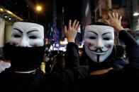 Protesters wearing Guy Fawkes masks attend an anti-government demonstration in Hong Kong