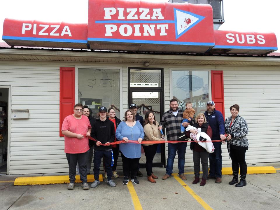 A ribbon cutting was recently held at Pizza Point at 301 Walnut St. to honor new owners Kayla and Casey Davis with employees and local officials.